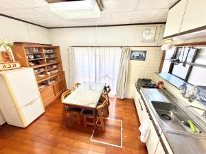 a small kitchen with a table and a sink at 別邸 先山 in Kamikatetsu