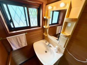 a bathroom with a sink and a mirror at 別邸 先山 in Kamikatetsu +11 photos