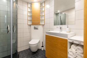 a bathroom with a sink and a toilet at TEN Apartments - Kuressaare in Kuressaare +12 photos