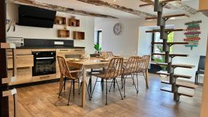 a dining room with a wooden table and chairs at Ty Neel - central - Wi-Fi in Crozon