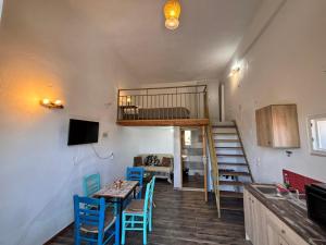 a room with a table and chairs and a bunk bed at Βαχος rooms 3 in Areopoli