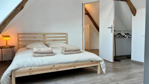 a bedroom with a wooden bed with pillows on it at Ty Neel - central - Wi-Fi in Crozon