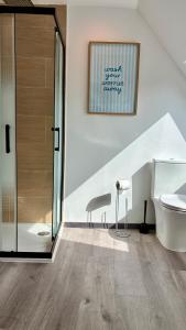 a bathroom with a shower and a toilet and a sink at Ty Neel - central - Wi-Fi in Crozon +21 photos