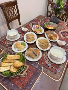 a table with plates of food on top of it at Silk Road Hostel in Bukhara