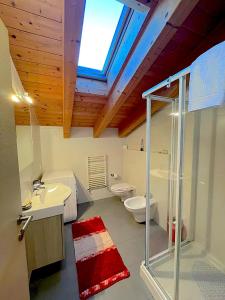 a bathroom with a glass shower and a toilet at ValtellinaHome in Villa di Tirano +8 photos