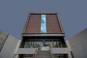 a building with stairs leading up to a hotel celebration at Hotel Joy in Chākan