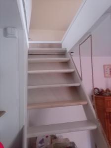 a staircase in a room with white walls at La Détente in Rinxent