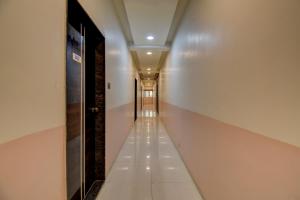 a hallway in a building with a long corridor at Hotel Joy in Chākan