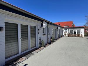 a row of garages parked next to a house at FEWO Priel Watt Nr.2 in Cuxhaven