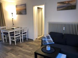 a living room with a couch and a table at FEWO Priel Watt Nr.2 in Cuxhaven