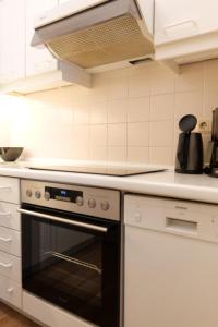 a kitchen with a stove top oven in a kitchen at Haus Trafalgar App 255 in Cuxhaven