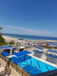 a swimming pool with a beach in the background at צימר מול ים תיכון in Ashkelon