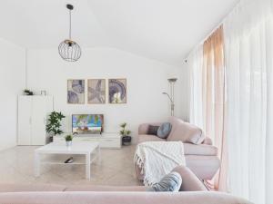 a living room with a couch and a table at Apartments Jan in Banjole