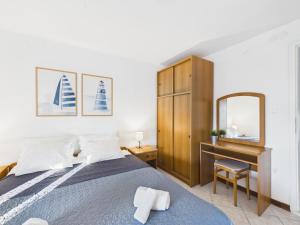 a bedroom with a bed and a desk and a mirror at Apartments Jan in Banjole