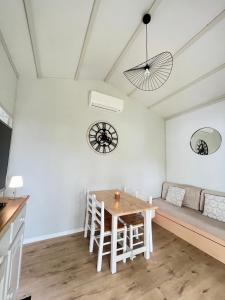 a dining room with a table and a couch at Chalet paisible in Rivières