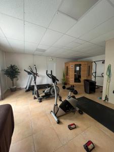 a gym with several exercise bikes in a room at Chalet paisible in Rivières