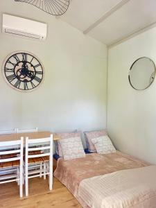 a bedroom with two beds and a clock on the wall at Chalet paisible in Rivières +17 photos
