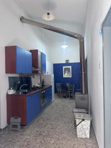 a kitchen with blue cabinets and a table in it at Vico Poerio 1 in Tursi