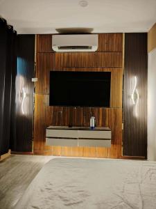 a room with a television on a wooden wall at The Barracks Staycation - Transient in Santa Rosa +6 photos