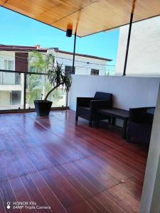 a patio with a table and benches on a wooden floor at The Barracks Staycation - Transient in Santa Rosa
