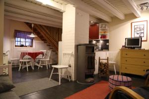 a living room with a fireplace and a table and chairs at Linkkumylly Cottages in Mäntyharju