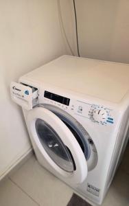 a white washing machine sitting in a room at Centrál apartmán in Zvolen