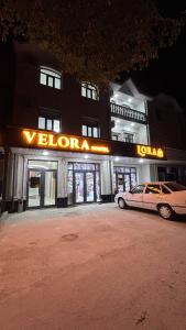 a car parked in front of a building at night at Velora Hostel in Khiva