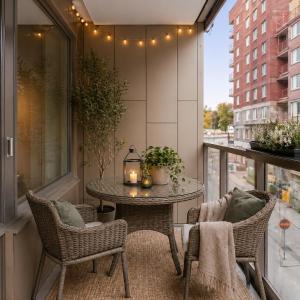a patio with a table and chairs on a balcony at Perfect cosy living in Stockholm
