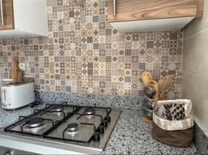 a kitchen with a stove top in a kitchen at Le Balcon Bohème des Golfs in Marrakesh