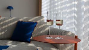 two wine glasses on a table on a couch at Apartment Nordic in Veselé