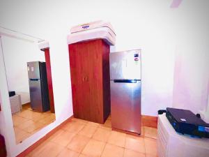 a kitchen with a refrigerator in a room at Beachside Studio Apartment Baga in Baga