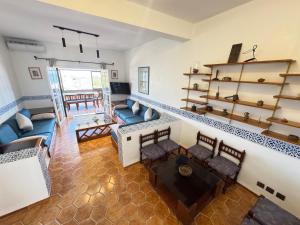 a living room with couches and shelves at C2 Résidence CHATT in Tétouan