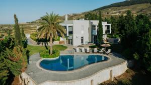 an aerial view of a house with a swimming pool at Breathtaking view guesthouse in Psalidi