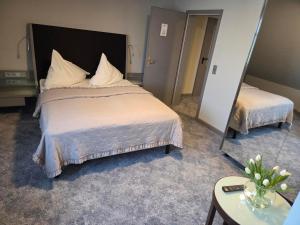 a bedroom with a large bed and a mirror at Hotel zur Kaiserpfalz in Kaiserpfalz