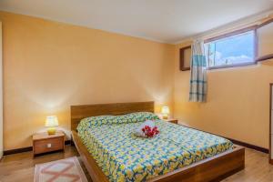 a bedroom with a bed with flowers on it at Rai's Private Apt 3 - Panorama & Relax in Stazione Olbia