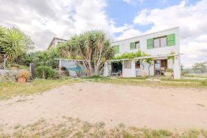 a white house with a palm tree in front of it at Rai's Private Apt 3 - Panorama & Relax in Stazione Olbia