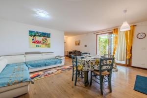 a living room with a bed and a table and chairs at Rai's Private Apt 3 - Panorama & Relax in Stazione Olbia