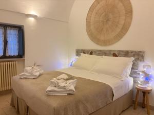 a bedroom with a bed with towels on it at Trulli Vulés in Ostuni