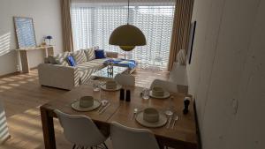 a living room with a table and chairs and a couch at Apartment Nordic in Veselé