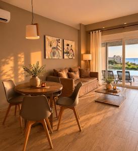 a living room with a couch and a table at Galinio Boutique Apartments in Skafidia