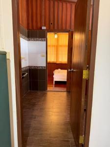 a hallway with a door to a room with a bed at Bann Maii Soi 14 in Ban Hua Khao Sammuk