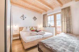 a bedroom with a bed and a window at Appartementhaus Söllbacherhof in Fügen +125 photos