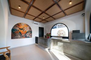 a lobby of a building with a painting on the wall at Tepi Segara Seminyak in Seminyak