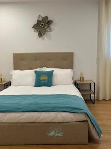 a bedroom with a large bed with a flower on the wall at Quintal de São Marcos in Castelo Branco