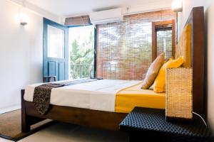 a bedroom with a bed and a large window at Lavanga Express in Hikkaduwa +9 photos