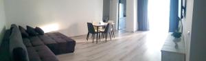 a living room with a couch and a table at Studio zona centrala in Craiova