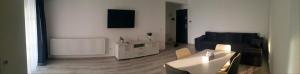 a living room with a couch and a table at Studio zona centrala in Craiova