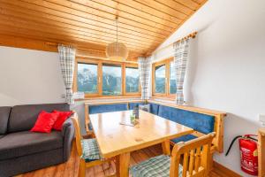 a living room with a table and a couch at Kesslerhütte Planai - by myNests in Schladming +17 photos