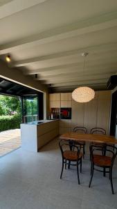 a kitchen and dining room with a table and chairs at Chosen Hideaway Near Cologne in Neunkirchen-Seelscheid +29 photos