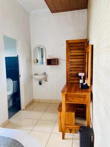 a bathroom with a sink and a toilet at De La Sierra in Munduk +122 photos